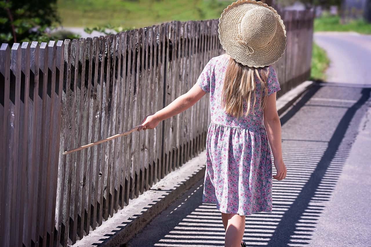 wooden picket fence and a girl